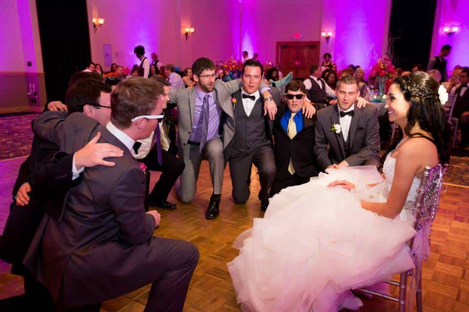 The Groom getting the Garter from the Bride at Mission Inn. Lighting by Our DJ Rocks 