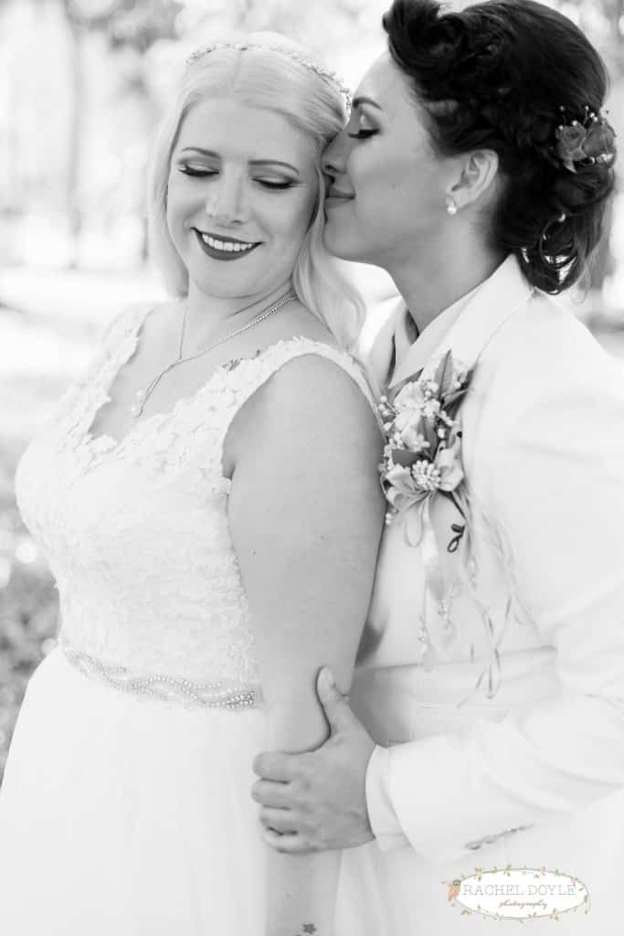 Same sex orlando wedding. Floral wedding hair pieces. Lace wedding dress. Black and white wedding photo. 