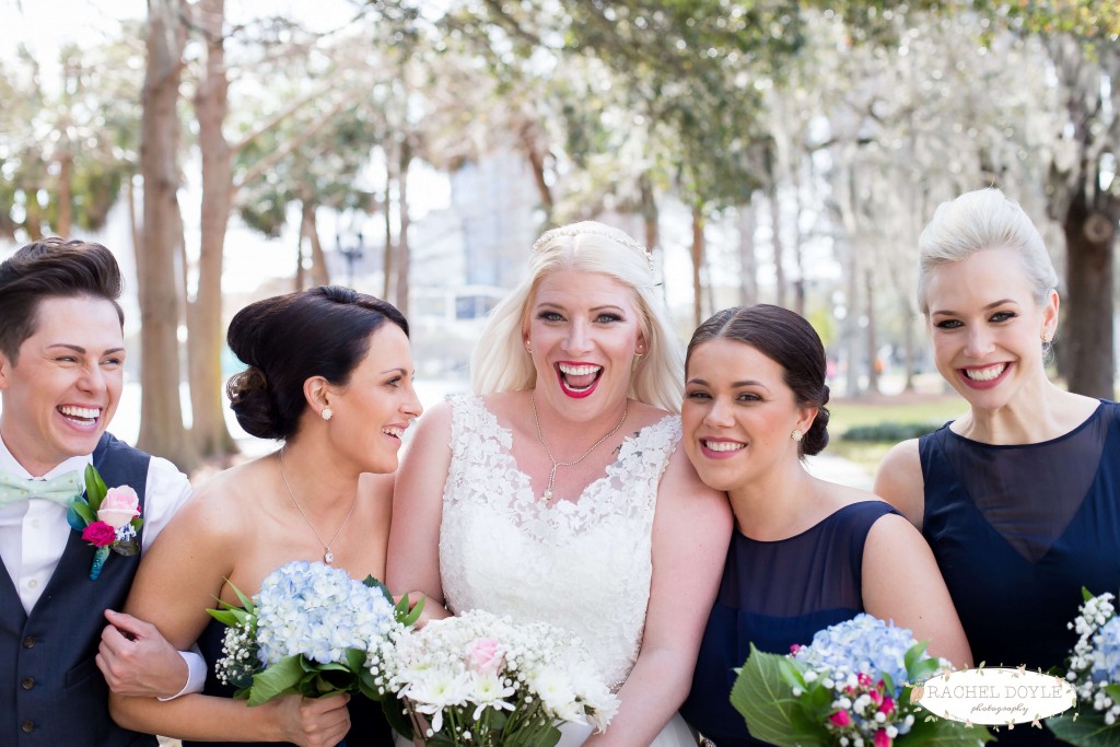 Wedding party photo at The Veranda. Navy blue brides maids dresses. Lace wedding dress. Blue flower bouquet. White flower bouquet. 