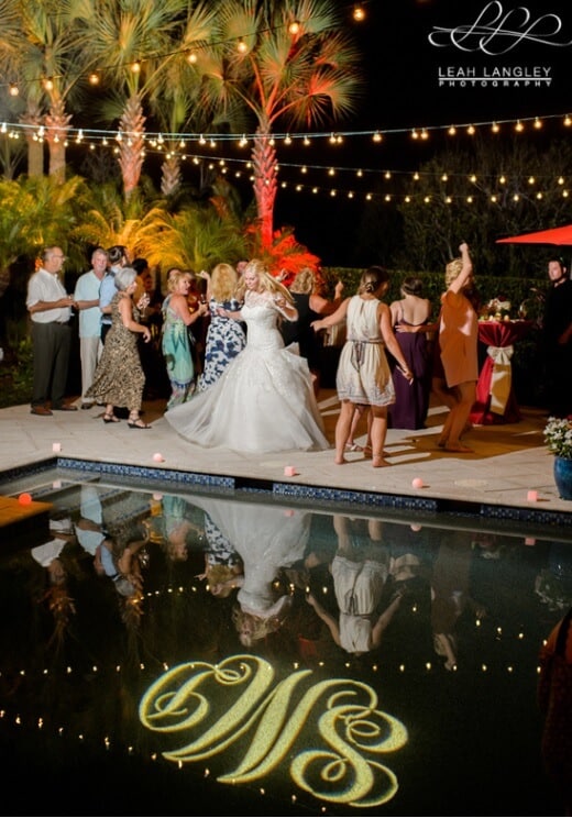 Private Residence Orlando Wedding with market lighting and gobo on pool water and red uplighting in background 