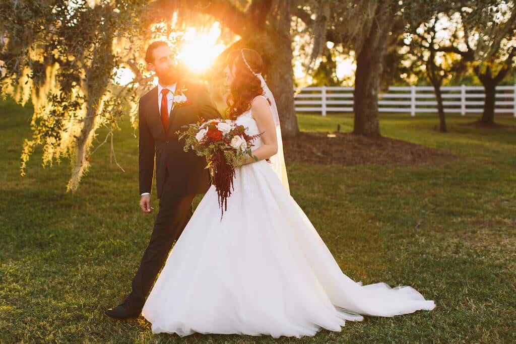 Bride and groom outdoor wedding photo at Up the Creek Farm with sunset in background
