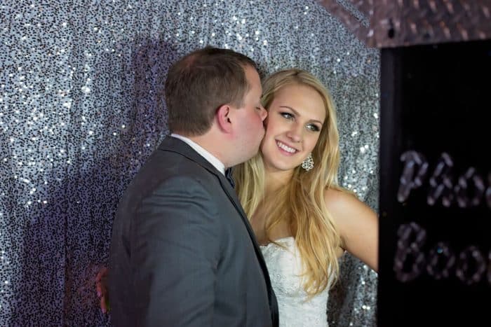 Female DJ in Orlando at Bella Collina wedding photo booth with sliver sparkly back drop provided by Photo Booth Rocks