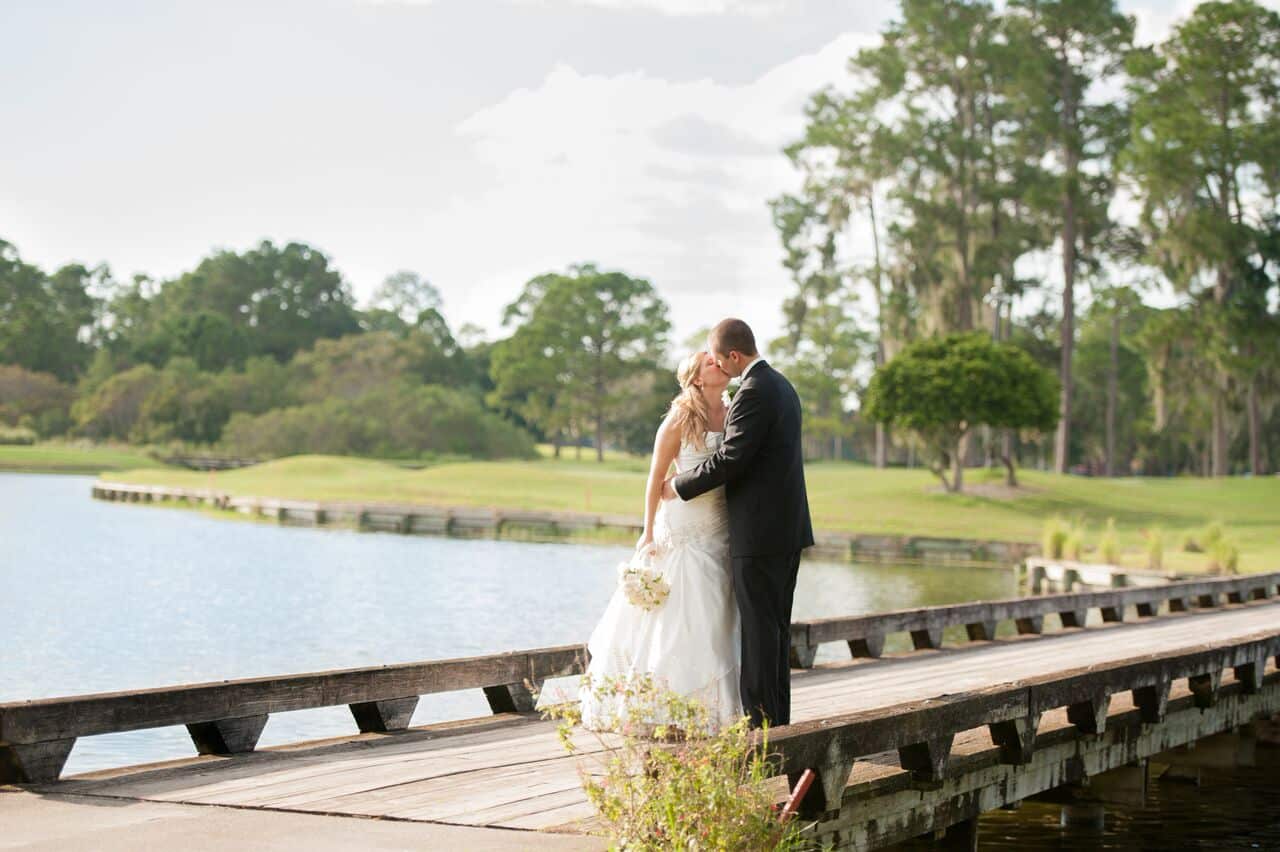 female wedding dj at Timacuan Country Club wedding bride and groom on bridge over water outside