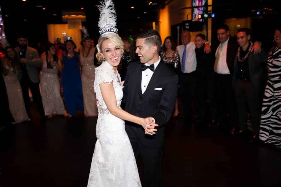 orlando wedding DJ at the Mezz NYE wedding bride and groom dancing with new years props