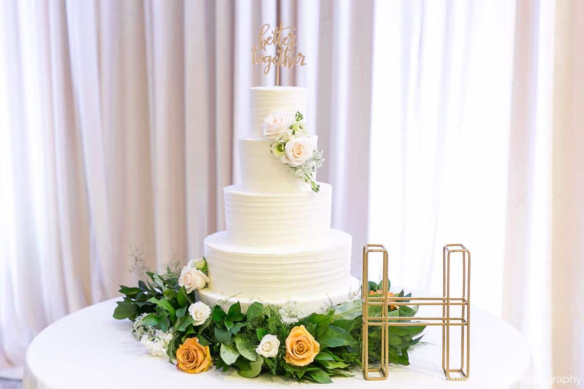 wedding cake with white uplighting at alfond inn 