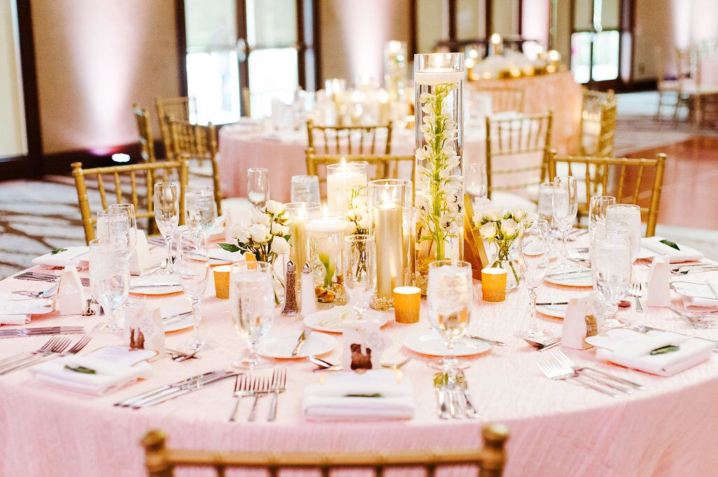 Villas of Grand Cypress Wedding reception table decor with blush pink uplighting 