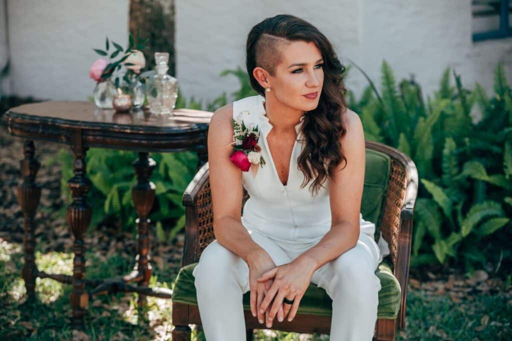 bride in jumpsuit waiting in chair