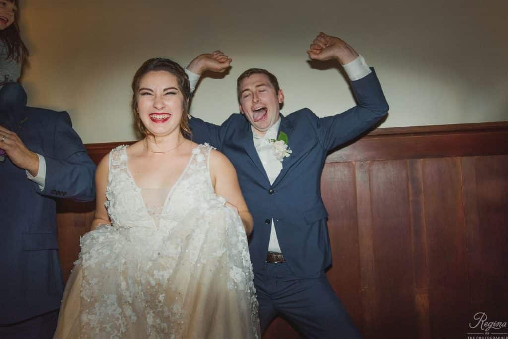 bride and groom acting silly