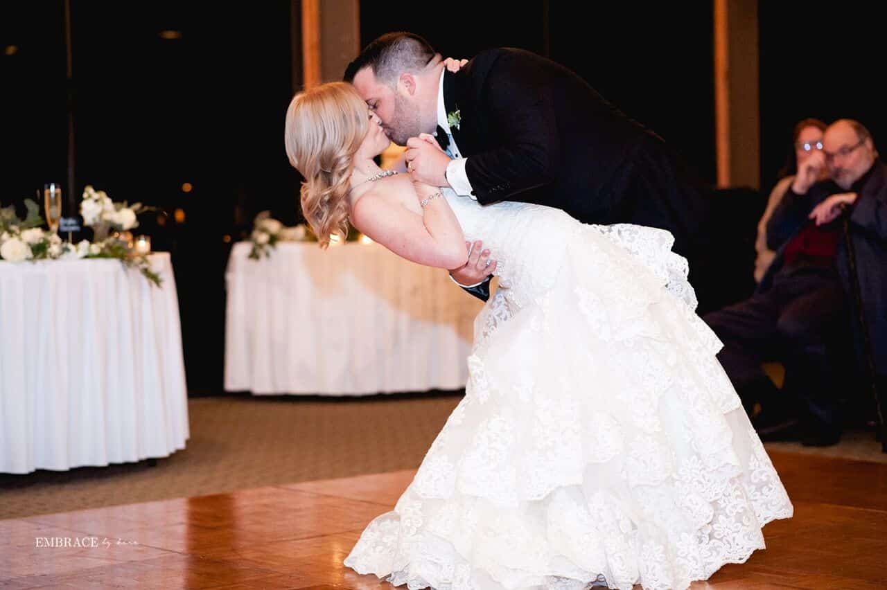 groom dipping and kissing bride on dance floor