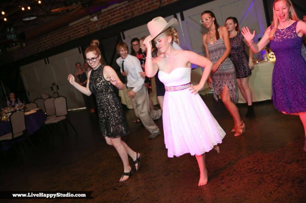 bride doing line dance in cowboy hat
