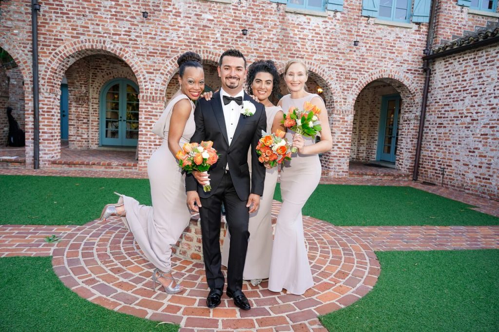 groom with bridesmaids in Casa Feliz courtyard