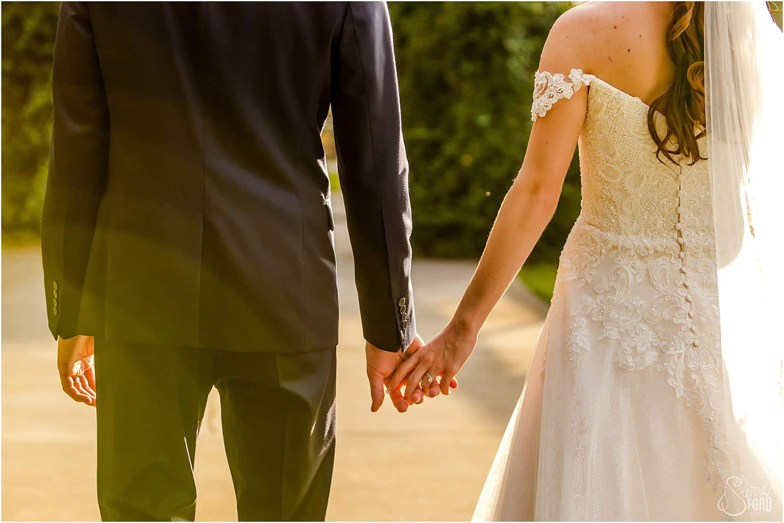 bride and groom holding hands