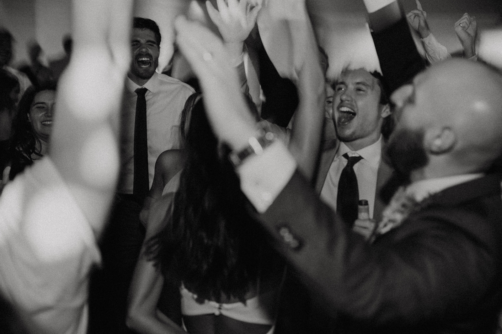 black and white shot of wedding guests on dance floor