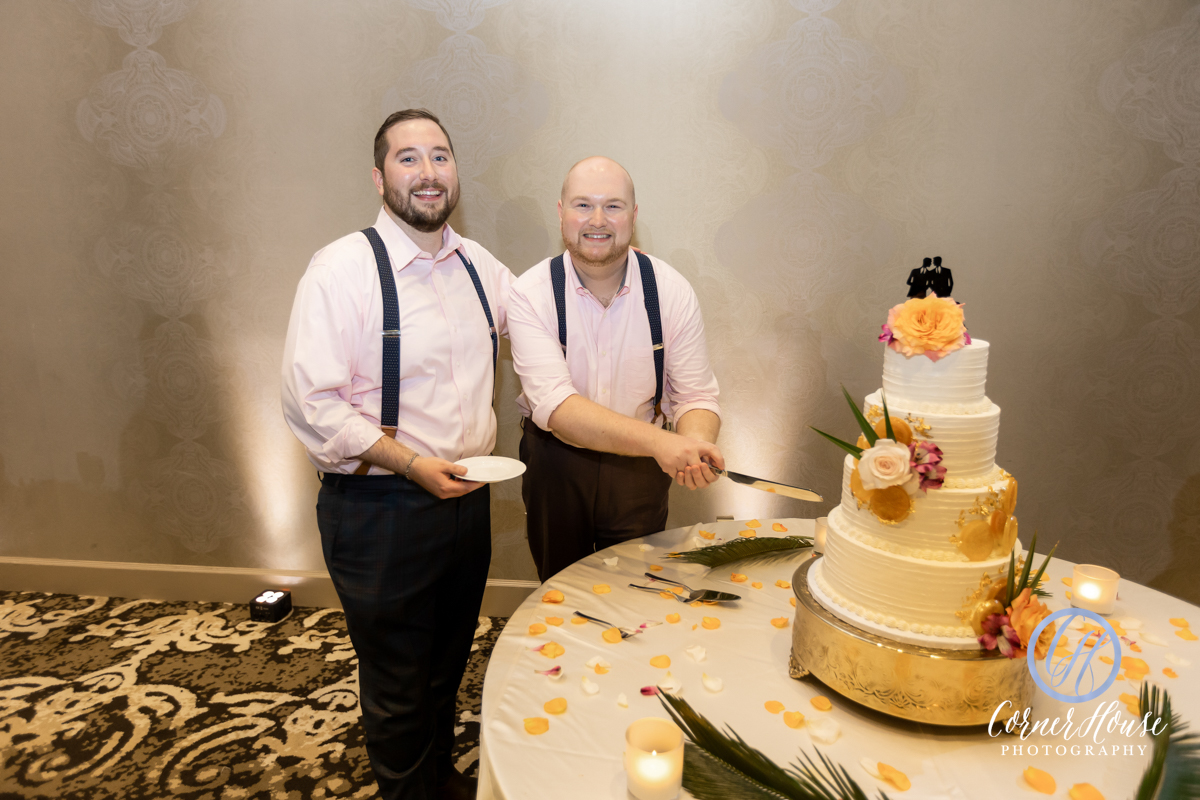 Matt and Chance cutting the cake at their wedding