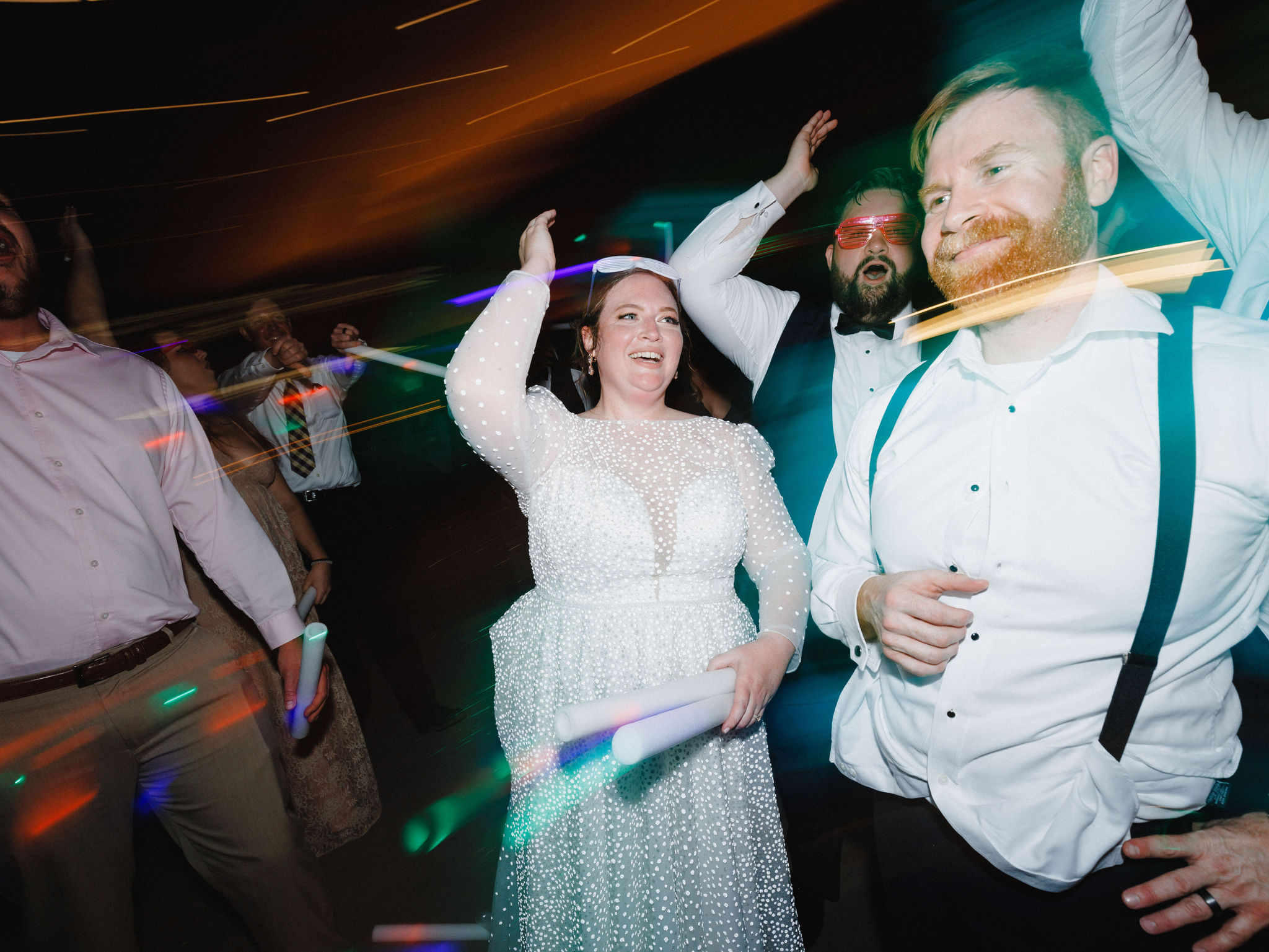 Katie and Bobby hit the dance floor with glow sticks at their wedding