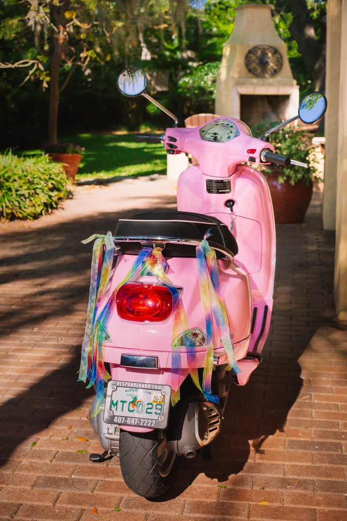 pink vespa with rainbow ribbon for wedding