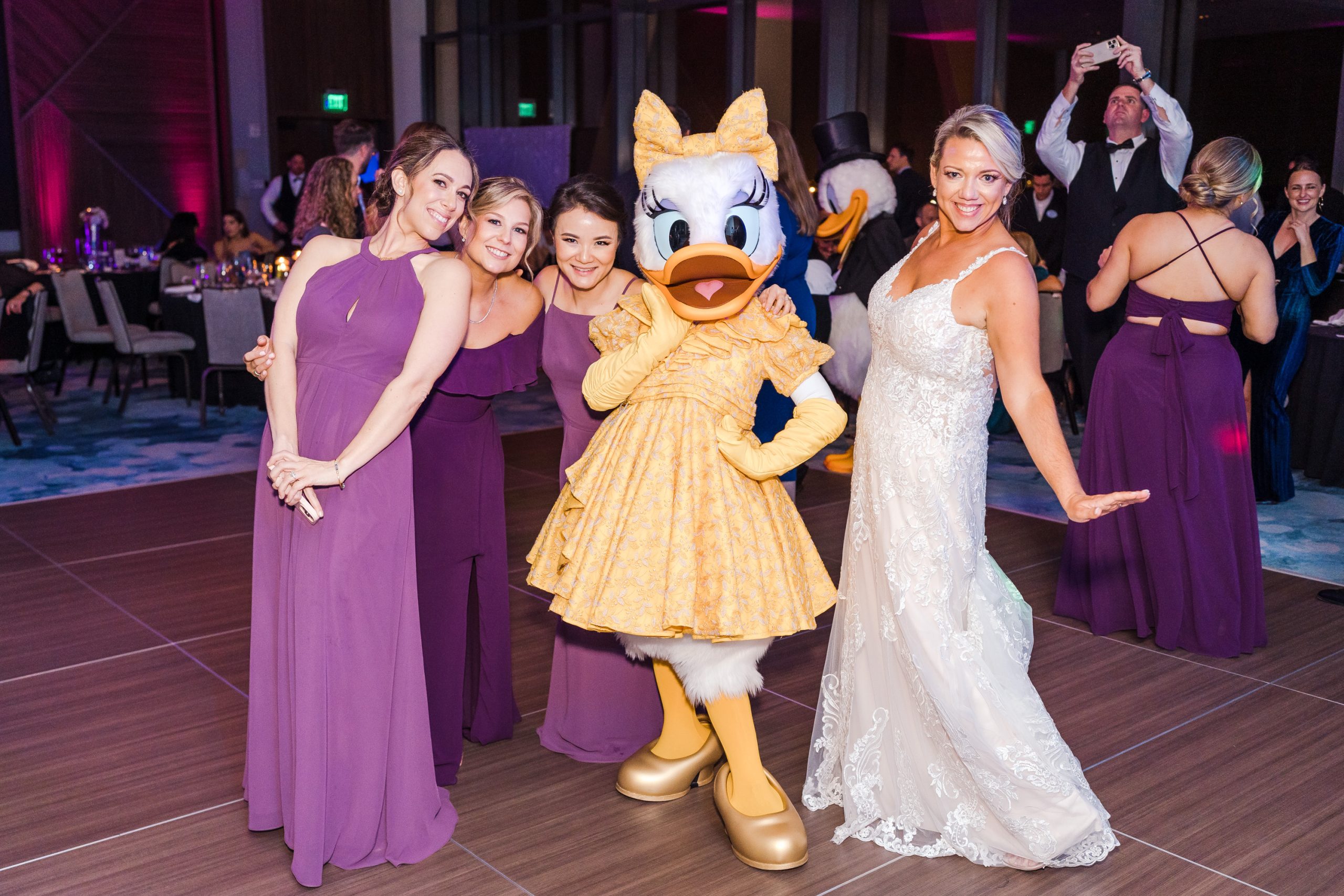 Daisy Duck posing with bride and bridesmaids