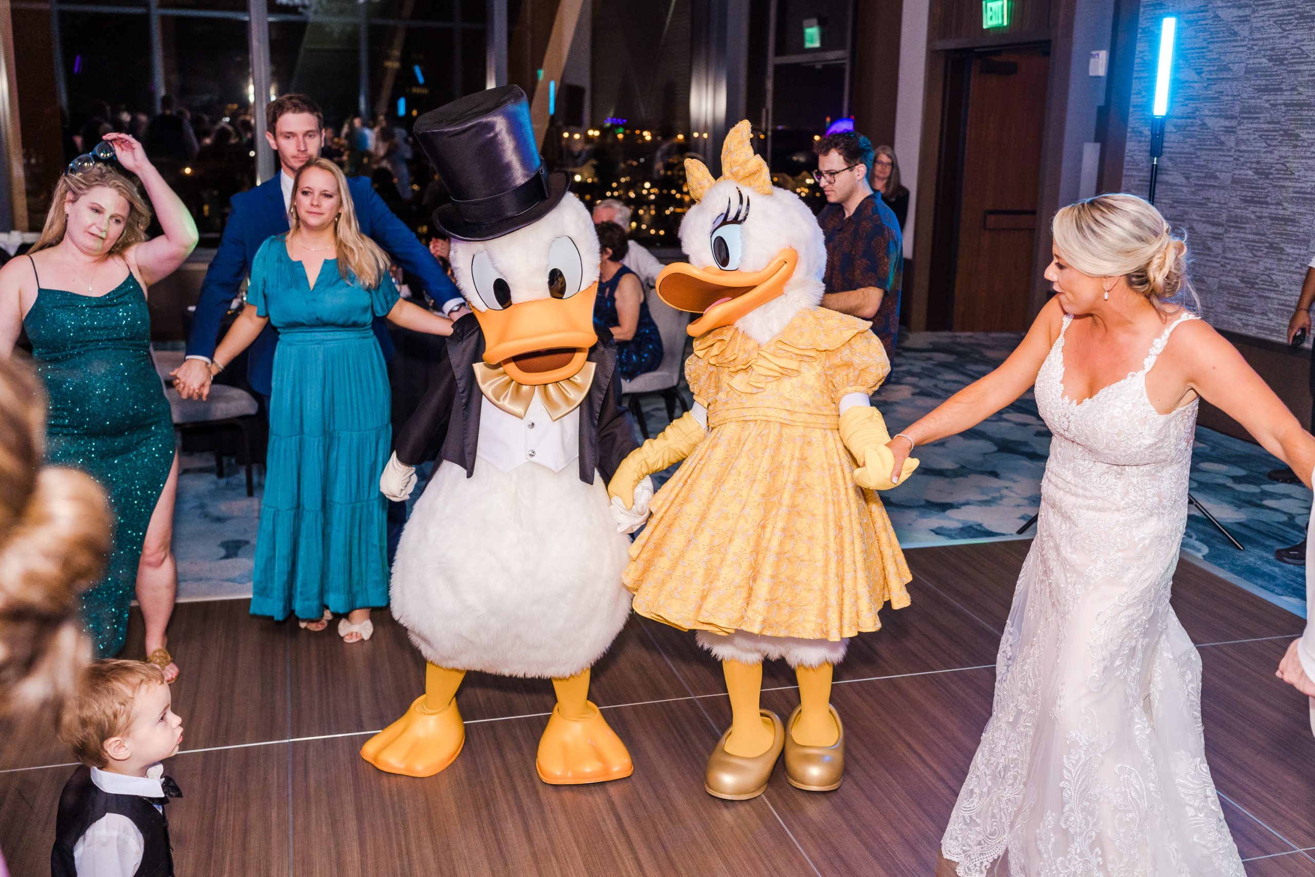 Donald and Daisy Duck dancing with bride