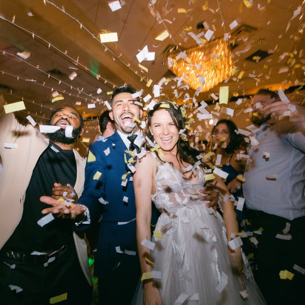 Bride and groom with confetti dancing to the last song song of their wedding