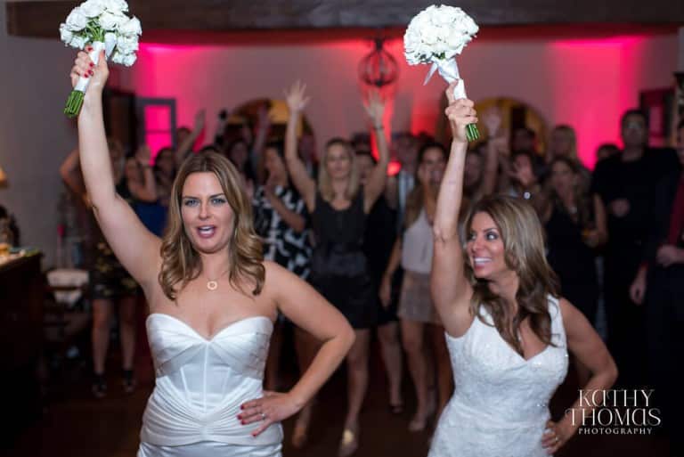 brides doing bouquet toss side by side