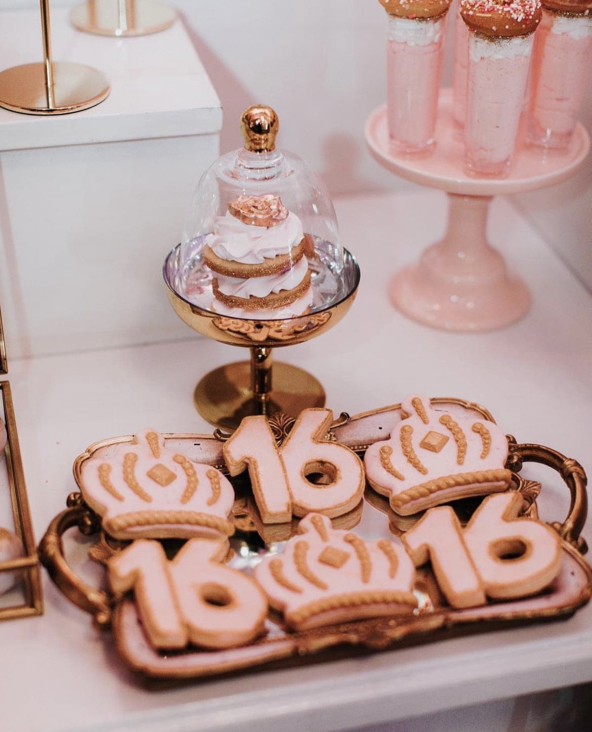 Cookies in the shape of a tiara and the number 16 for a Sweet 16 party