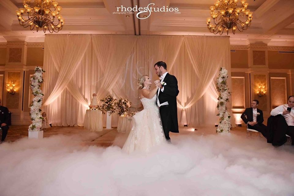 Couple dancing with surrounding fog at their wedding reception