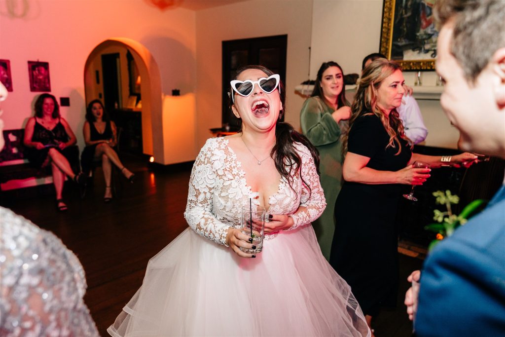bride wearing pink heart shaped sunglasses