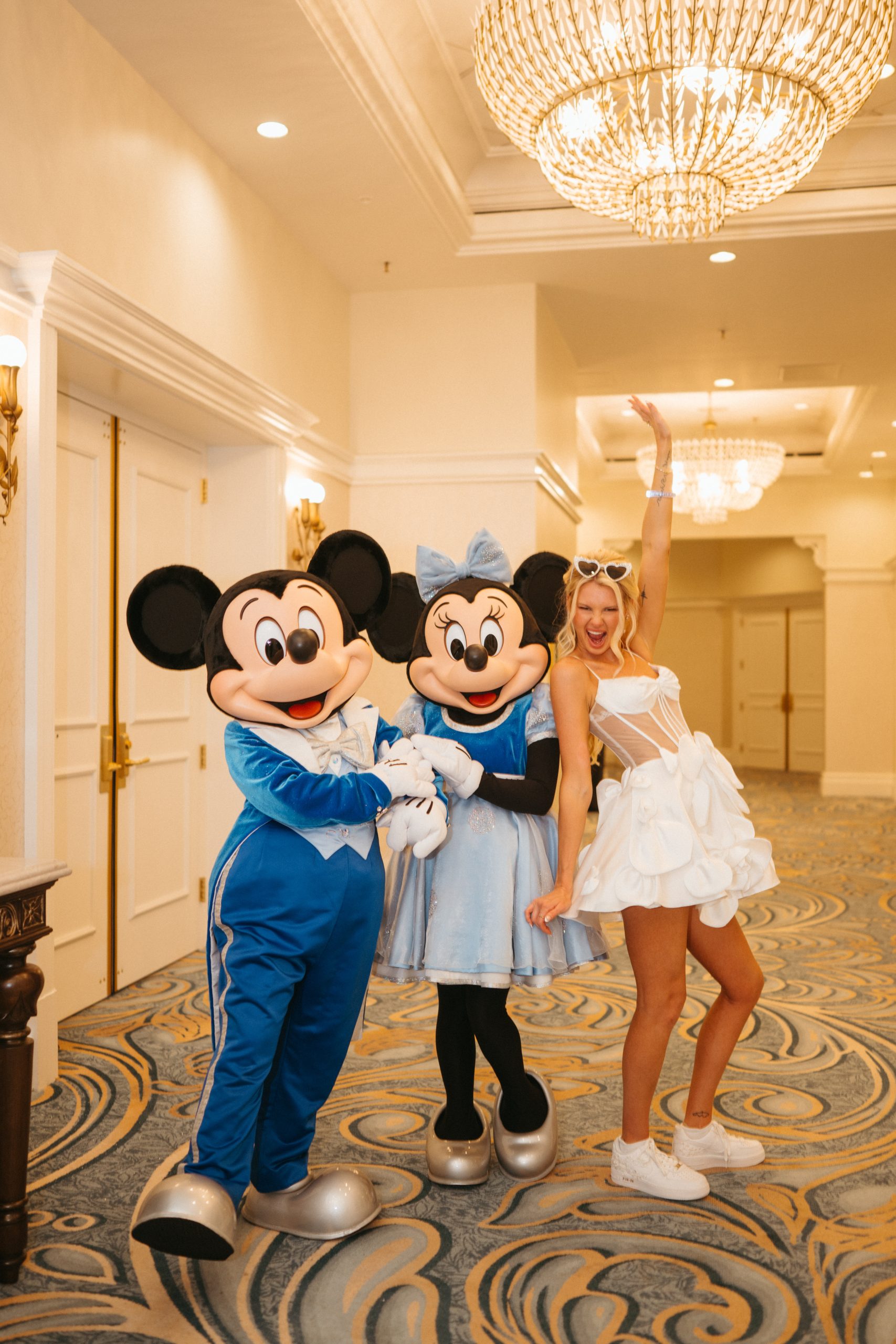 Bride posing with Mickey and Minnie