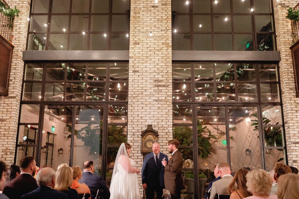 Guests gathered at cocktail hour and reception spaces inside Oxford Exchange wedding venue