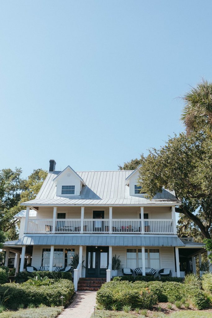 The white two-story Victoria 1883 Historic B&B house and porch in New Smyrna Beach, Florida